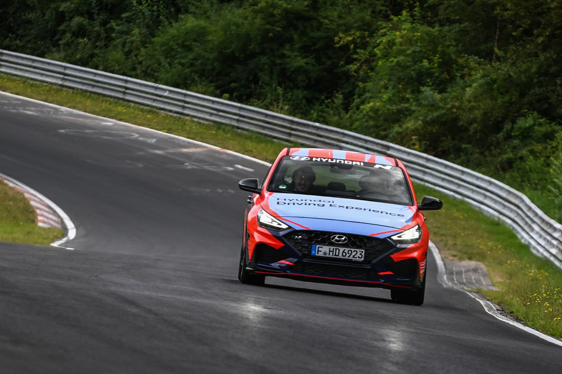 Hyundai N Taxi car driving on race track with passenger
