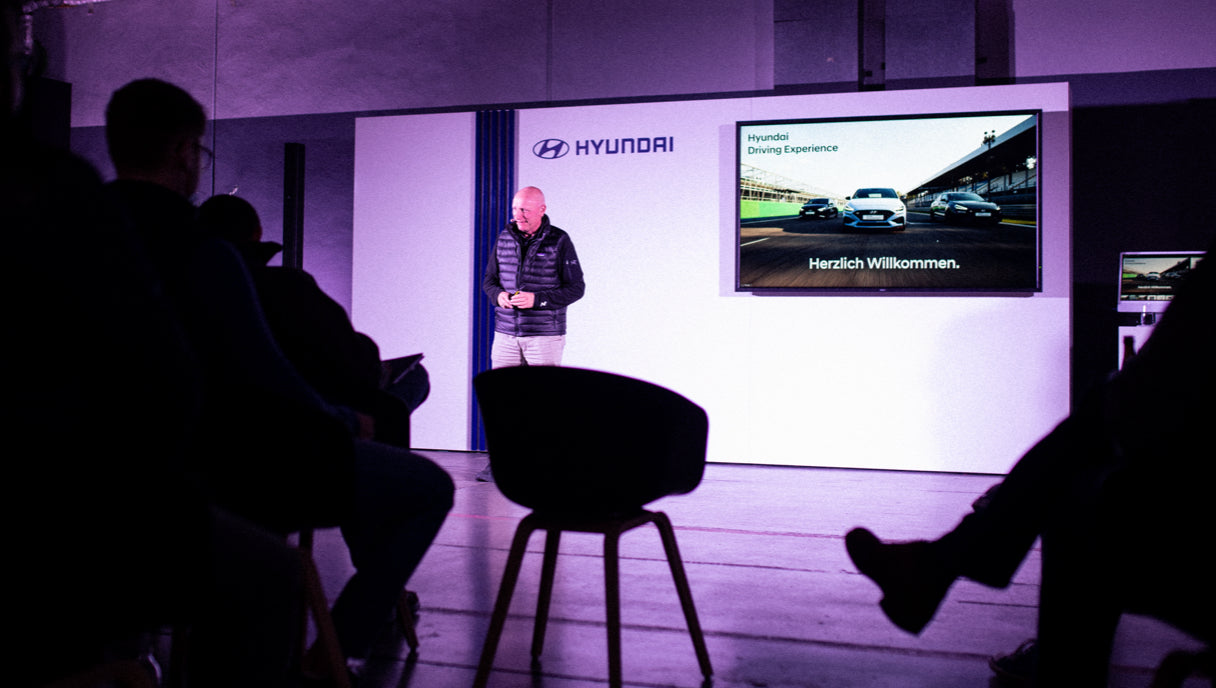 Hyundai Driving Experience instructor welcomes the participants to the theory lesson of a driving training
