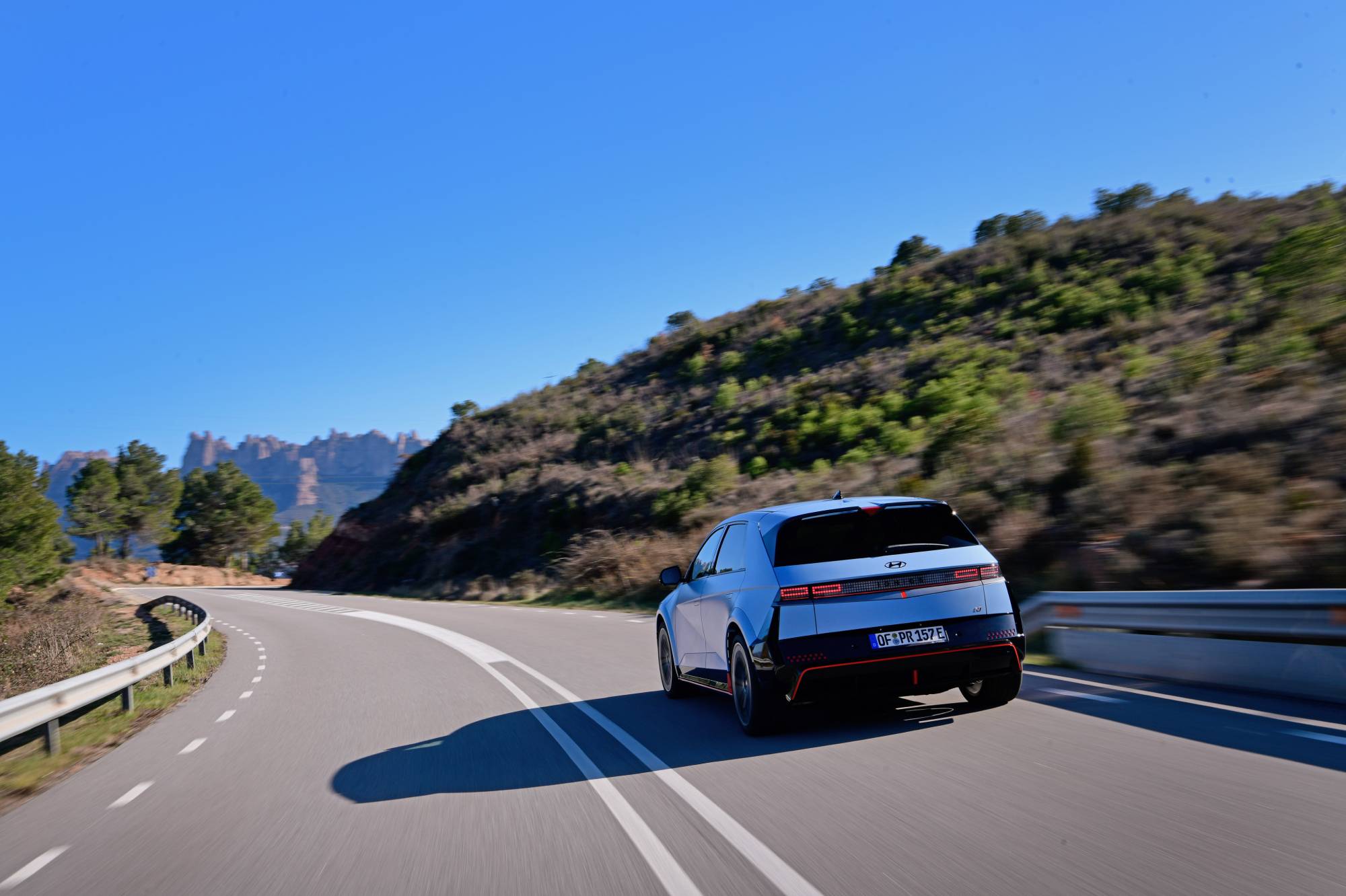 Hyundai IONIQ 5 N from behind driving on a sunny road
